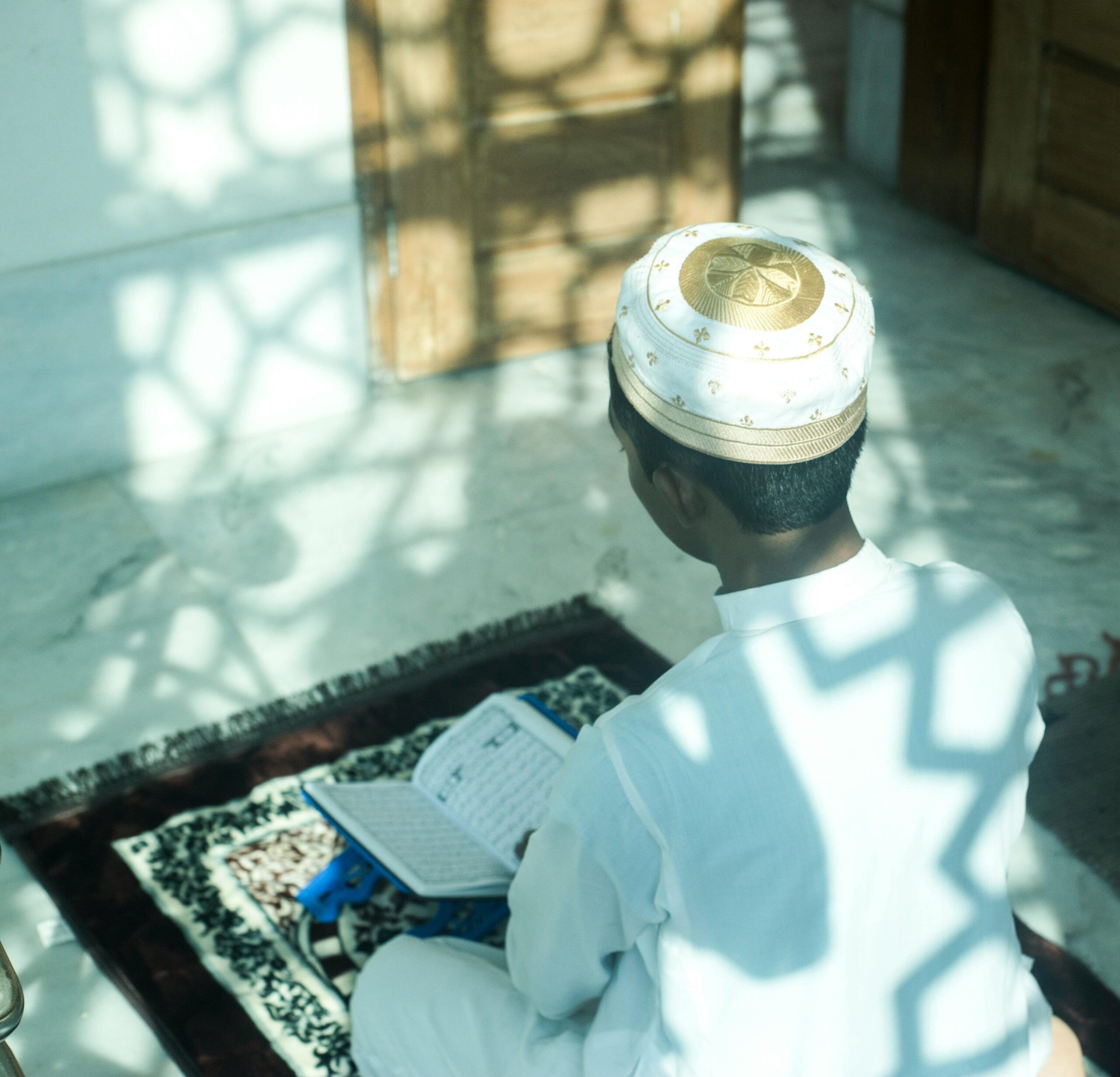 A black Asian muslim people reciting holy Quran in mosque